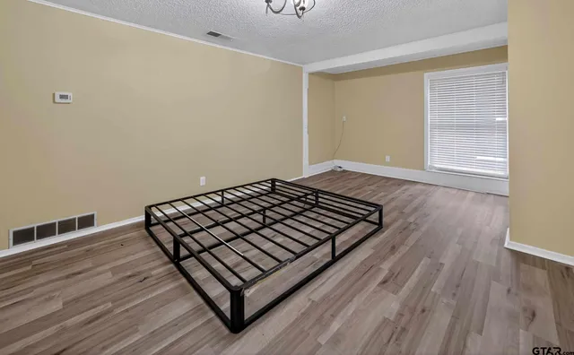 a view of a room with wooden floor