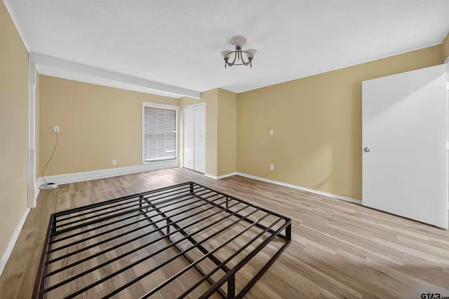 a bedroom with bed and a night stand