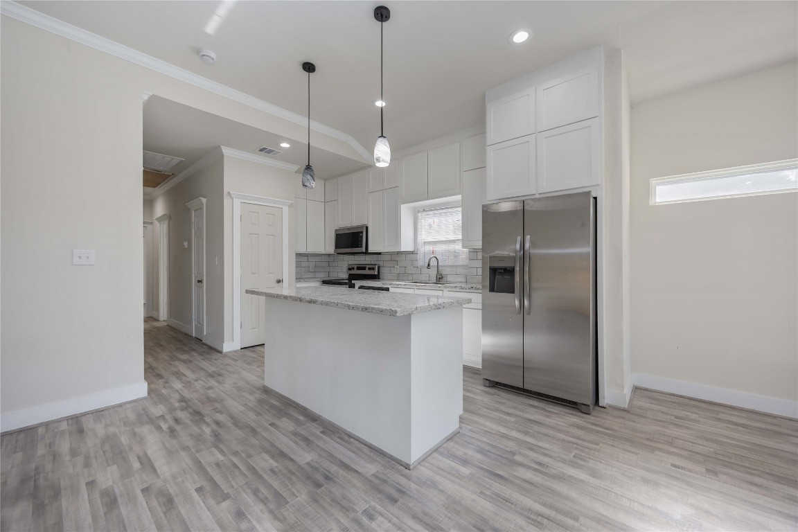 2708 Sam Wilson Street Houston, TX 77020 - Photo 4 of 18 a kitchen with stainless steel appliances a refrigerator sink and microwave