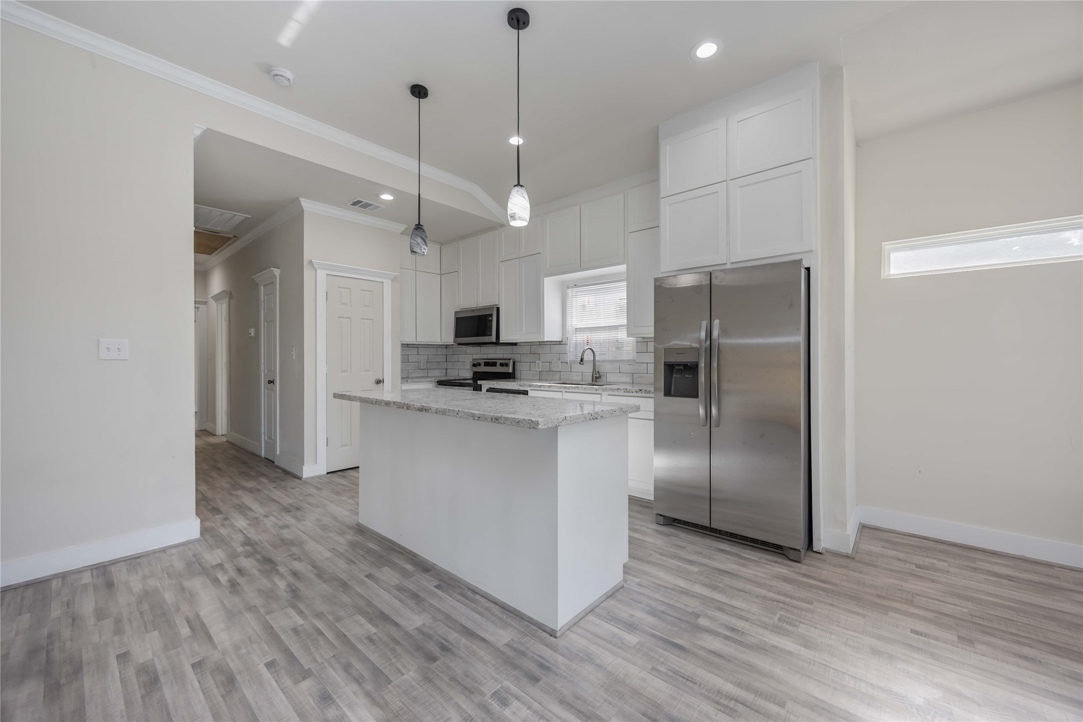 2708 Sam Wilson Street Houston, TX 77020 - Photo 4 of 18 a kitchen with stainless steel appliances a refrigerator sink and microwave