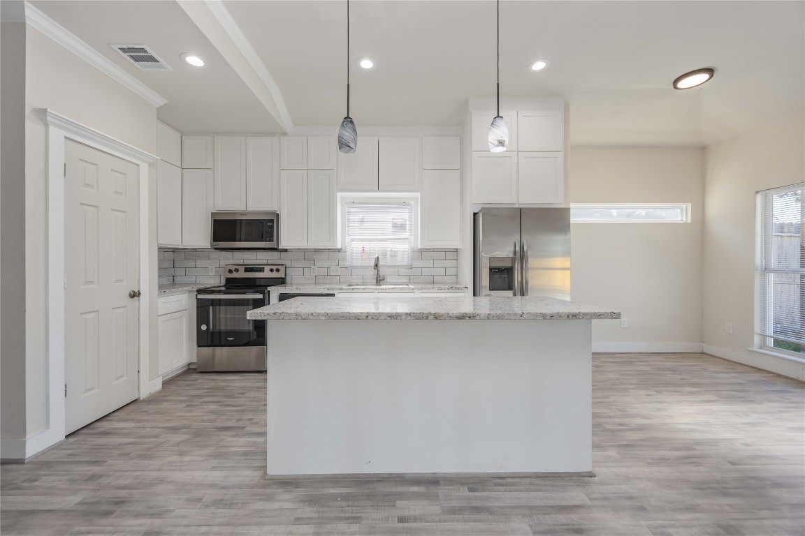 2708 Sam Wilson Street Houston, TX 77020 - Photo 5 of 18 a kitchen with kitchen island a sink stainless steel appliances and cabinets