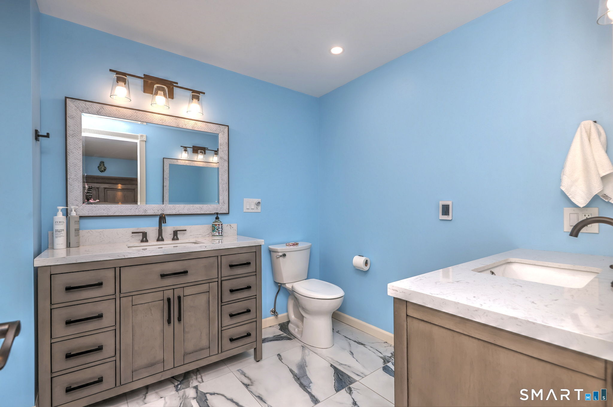 2262 Ridge Road North Haven, CT 06473 - Photo 9 of 40 a bathroom with a granite countertop toilet a sink and a mirror