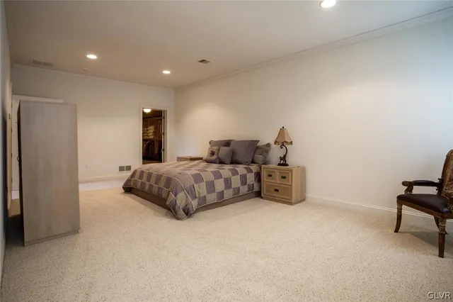 a bedroom with a bed and a chair