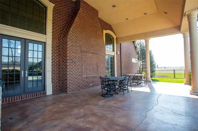 a view of a dinning tables and chairs in back of the house