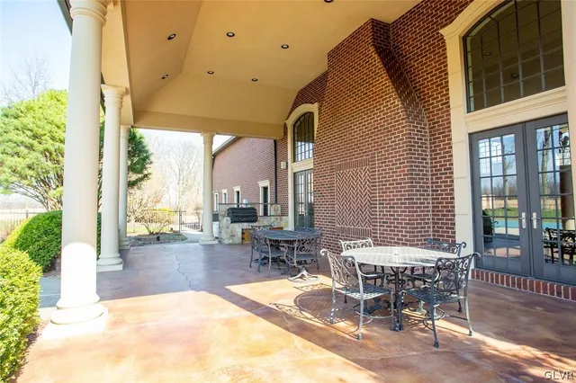 a view of a brick house with a bench