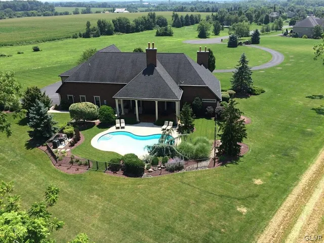 a view of backyard of house with green space