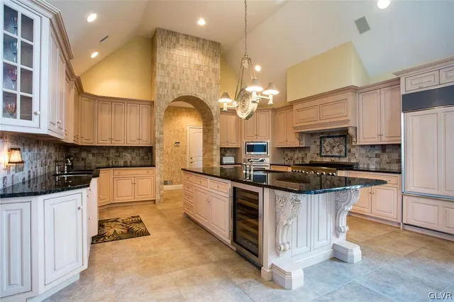 a kitchen with stainless steel appliances a sink a stove and cabinets