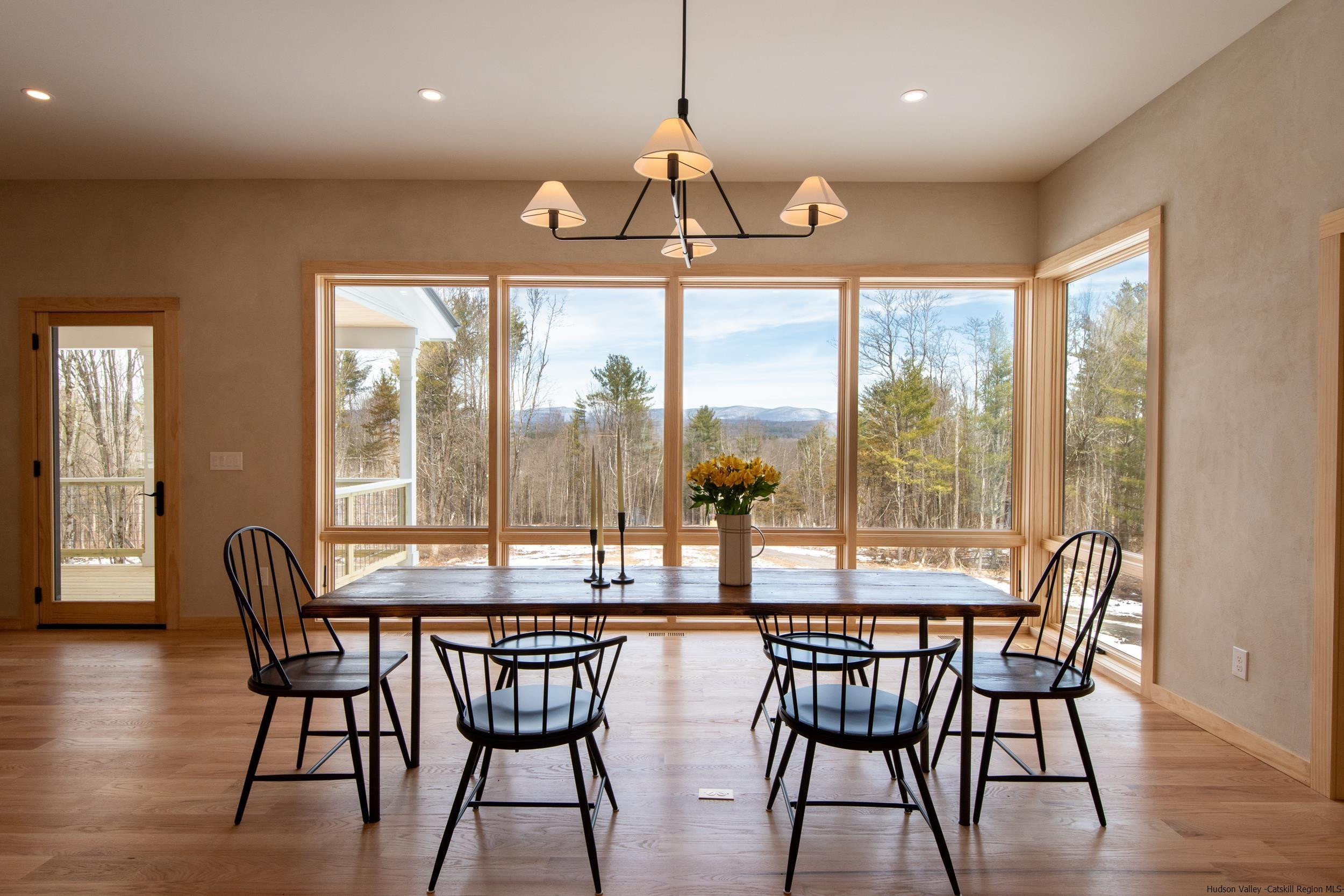 1622 Berme Road Kerhonkson, NY 12446 - Photo 11 of 33 a dining room with furniture a chandelier and wooden floor