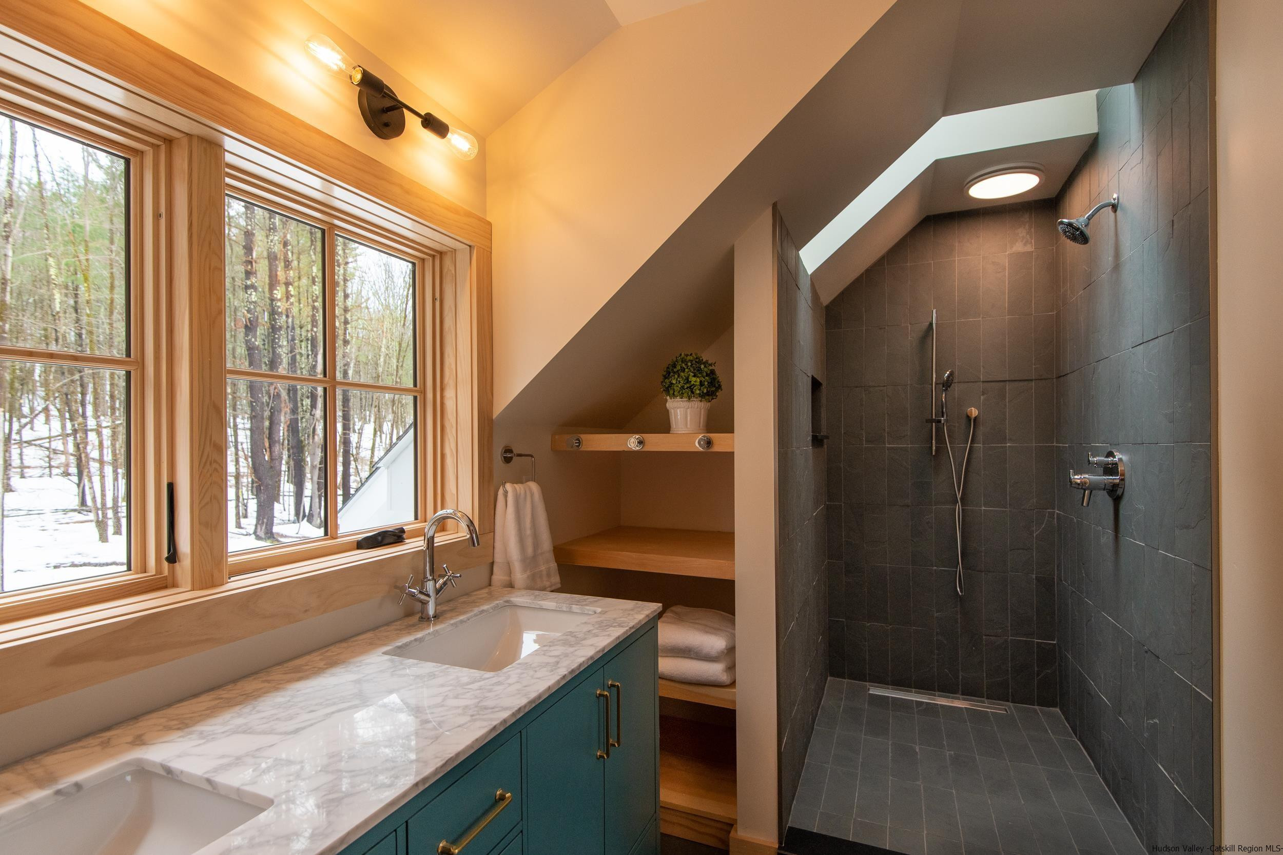 1622 Berme Road Kerhonkson, NY 12446 - Photo 23 of 33 a bathroom with a granite countertop sink and a large mirror