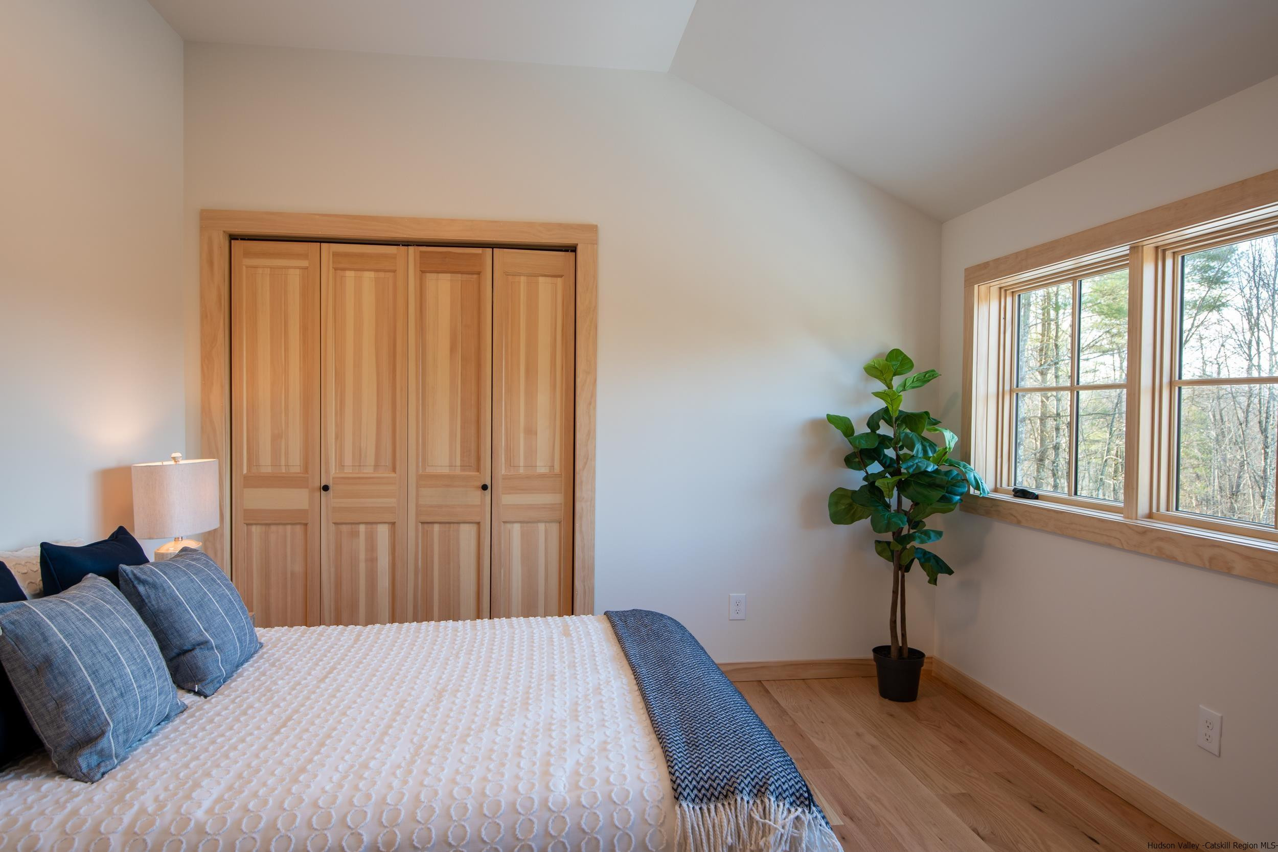 1622 Berme Road Kerhonkson, NY 12446 - Photo 25 of 33 a bedroom with a bed and a potted plant