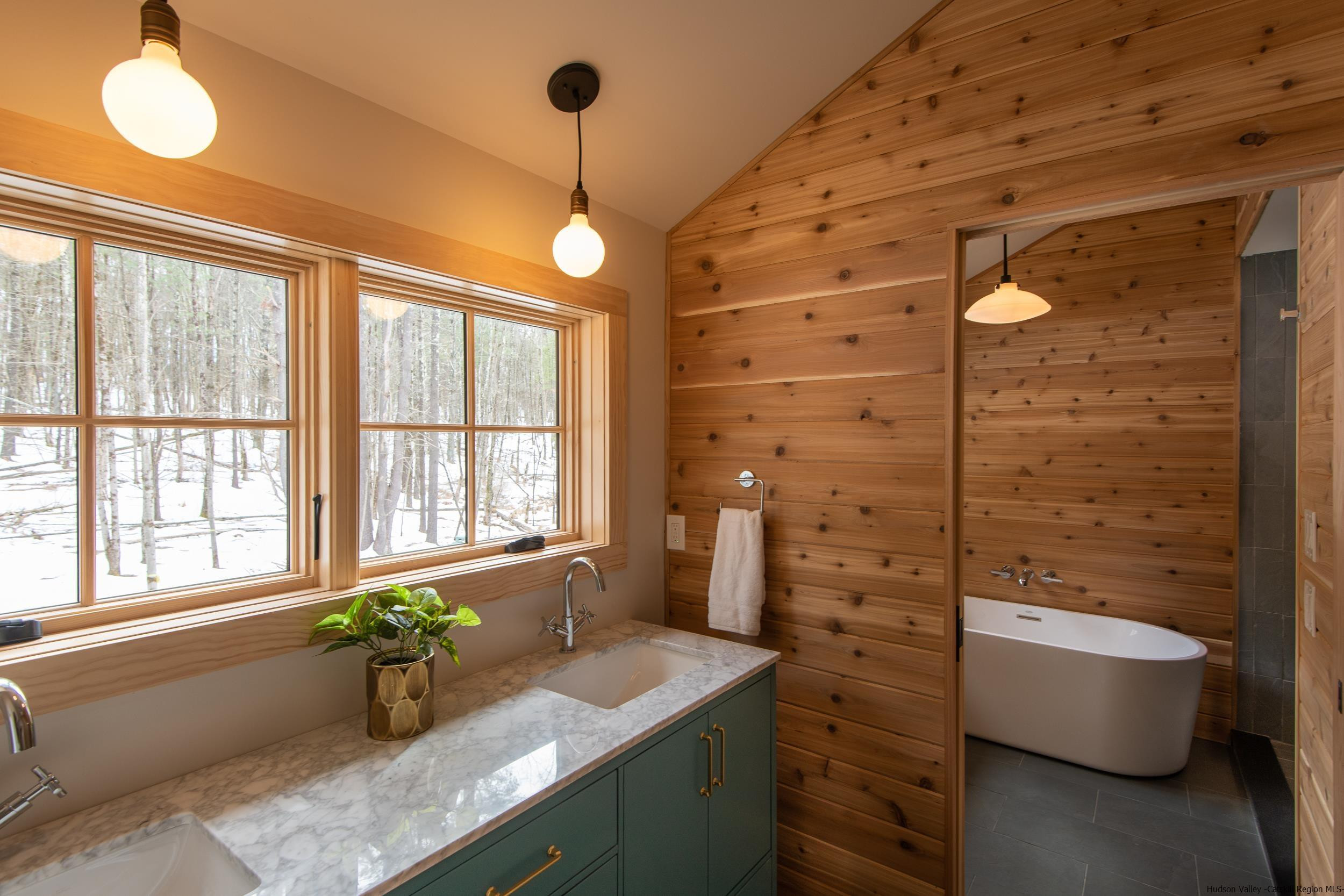 1622 Berme Road Kerhonkson, NY 12446 - Photo 29 of 33 a bathroom with a granite countertop sink a large mirror and a bathtub