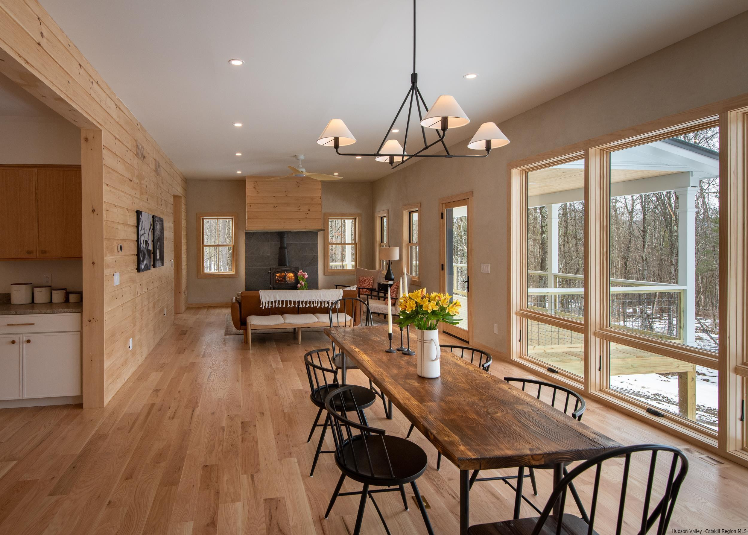 1622 Berme Road Kerhonkson, NY 12446 - Photo 10 of 33 a view of a dining room and livingroom with furniture wooden floor a chandelier