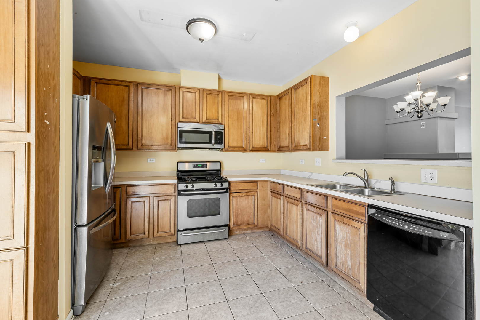 10233 Concord Lane, Unit C Bridgeview, IL 60455 - Photo 7 of 20 a kitchen with a sink stove and microwave