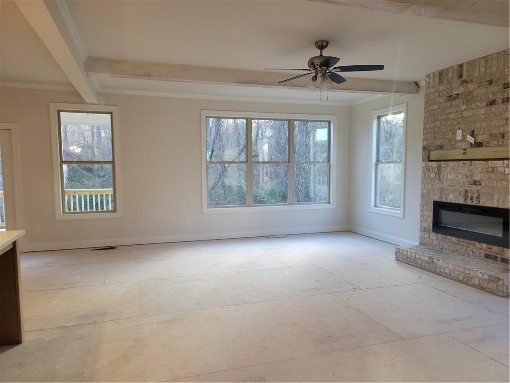 4795 Fairways Lane Jefferson, GA 30549 - Photo 7 of 20 a view of an empty room with a window and a fireplace
