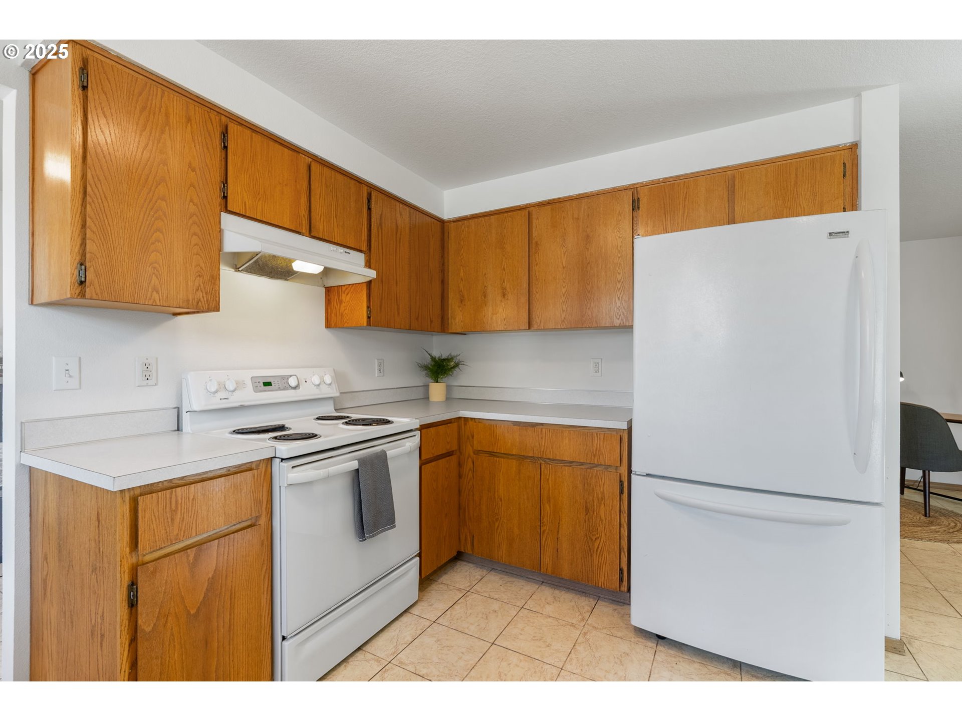 3196 Midway Road Hood River, OR 97031 - Photo 13 of 44 a kitchen with stainless steel appliances granite countertop a refrigerator a sink dishwasher and white cabinets with wooden floor