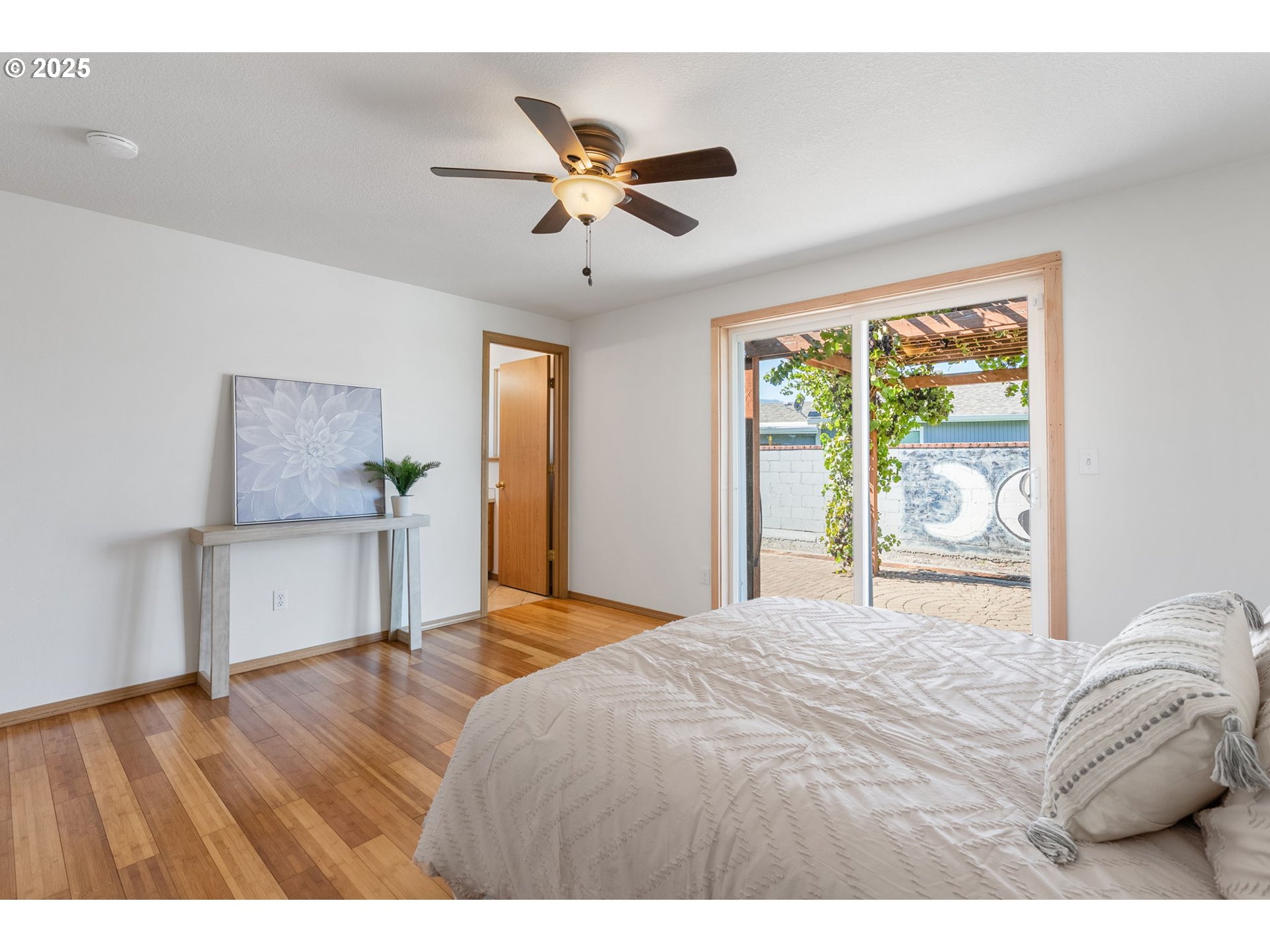 3196 Midway Road Hood River, OR 97031 - Photo 23 of 44 a bedroom with a large bed and a chandelier
