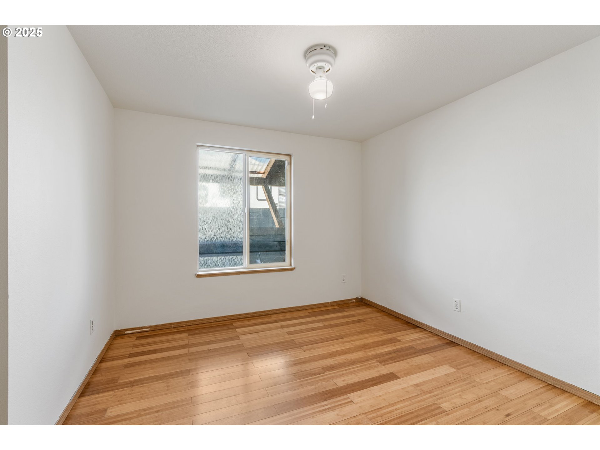 3196 Midway Road Hood River, OR 97031 - Photo 28 of 44 a view of empty room with wooden floor and fan