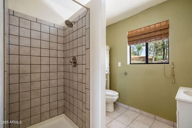 a bedroom with a large bed and a potted plant