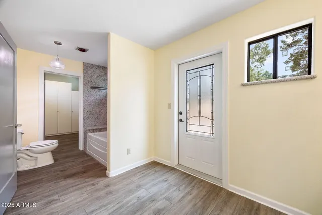 a bathroom with a granite countertop double vanity sink and mirror