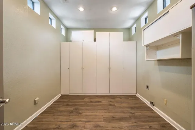 a bathroom with a granite countertop sink a mirror and bathtub