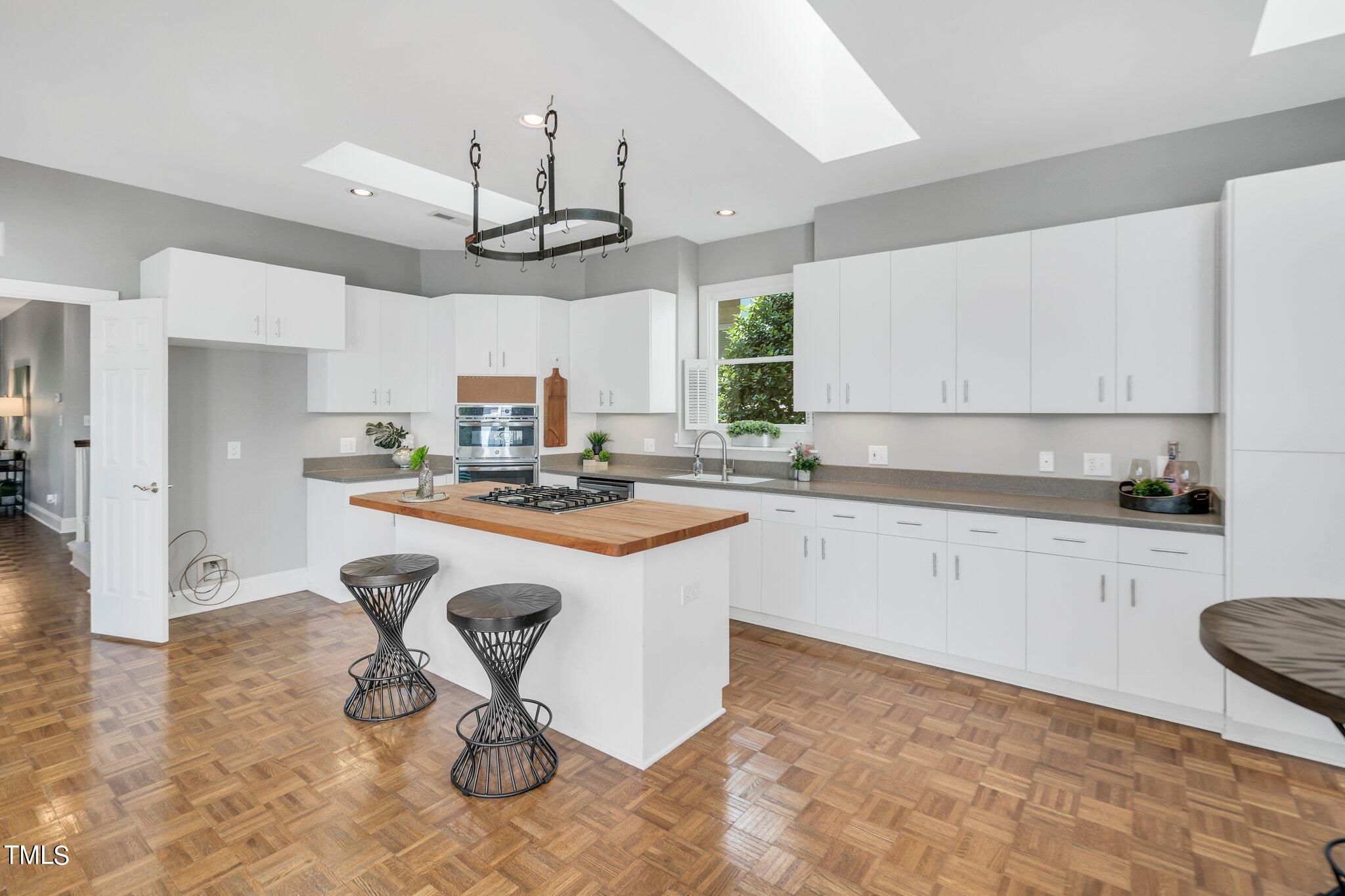 25 East Camden Pittsboro, NC 27312 - Photo 21 of 71 a kitchen with kitchen island granite countertop a stove a sink a counter space and cabinets
