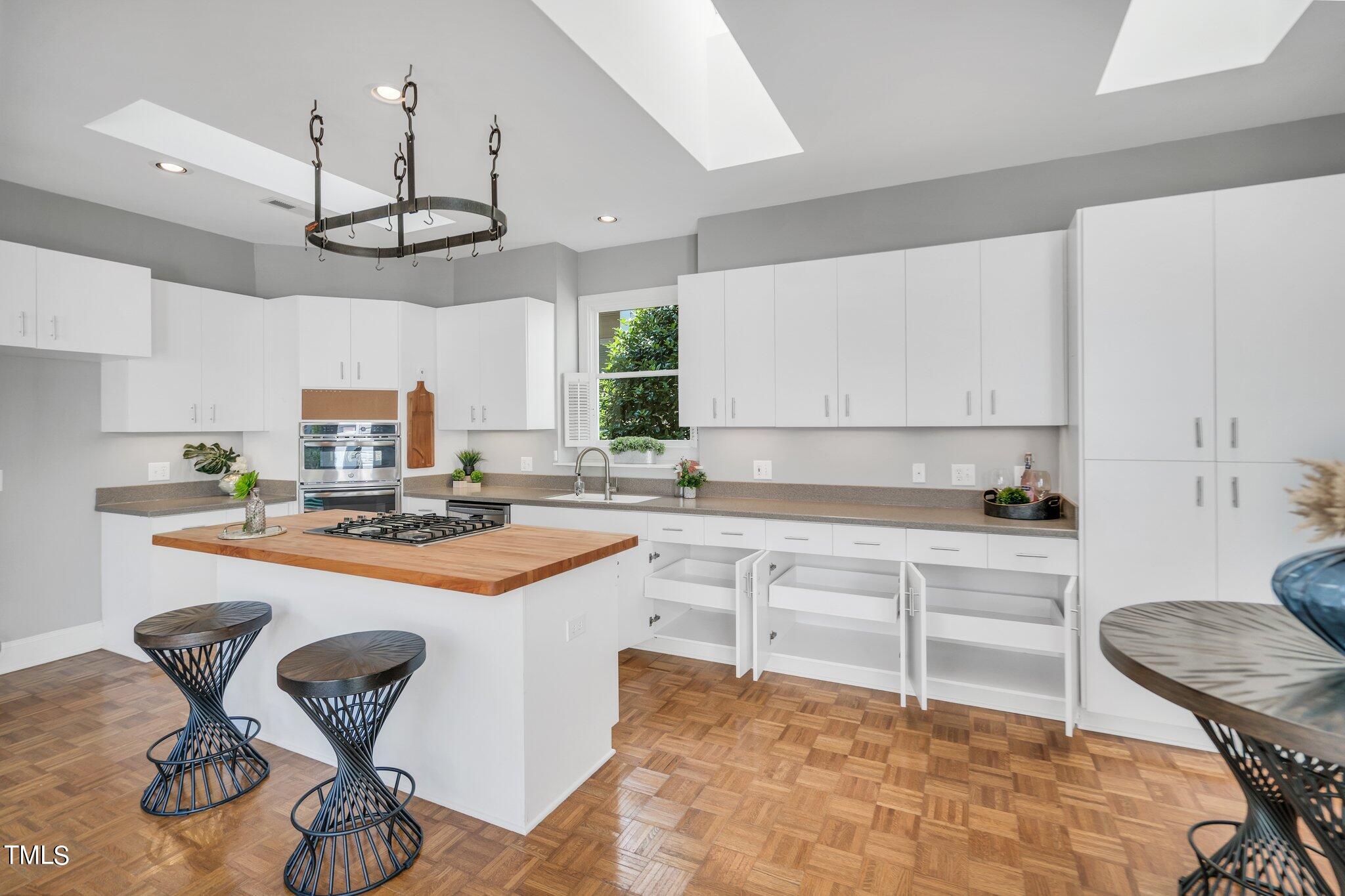25 East Camden Pittsboro, NC 27312 - Photo 28 of 71 a kitchen with stainless steel appliances a stove a sink cabinets and a dining table