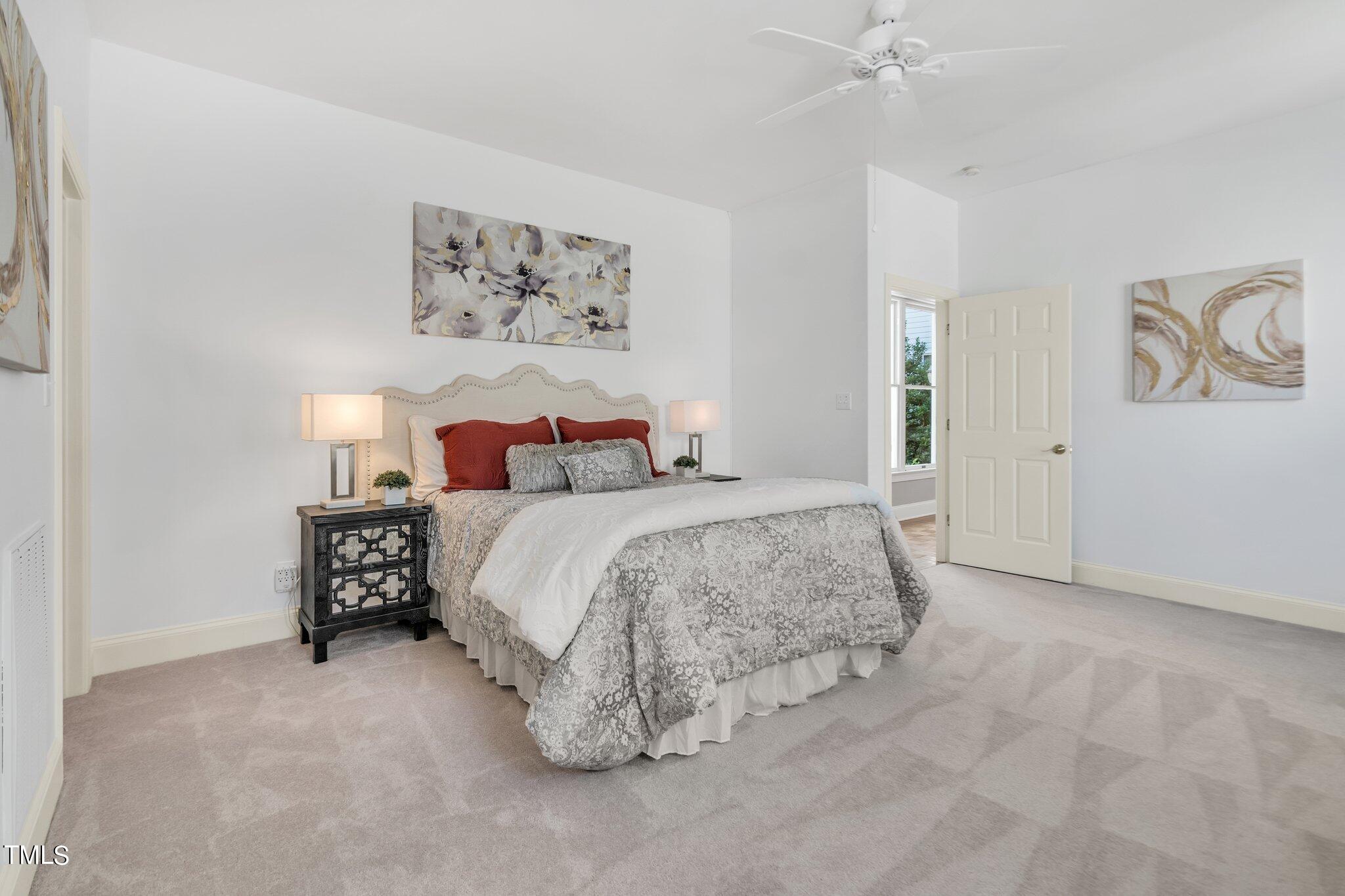 25 East Camden Pittsboro, NC 27312 - Photo 33 of 71 a spacious bedroom with a bed and a chandelier