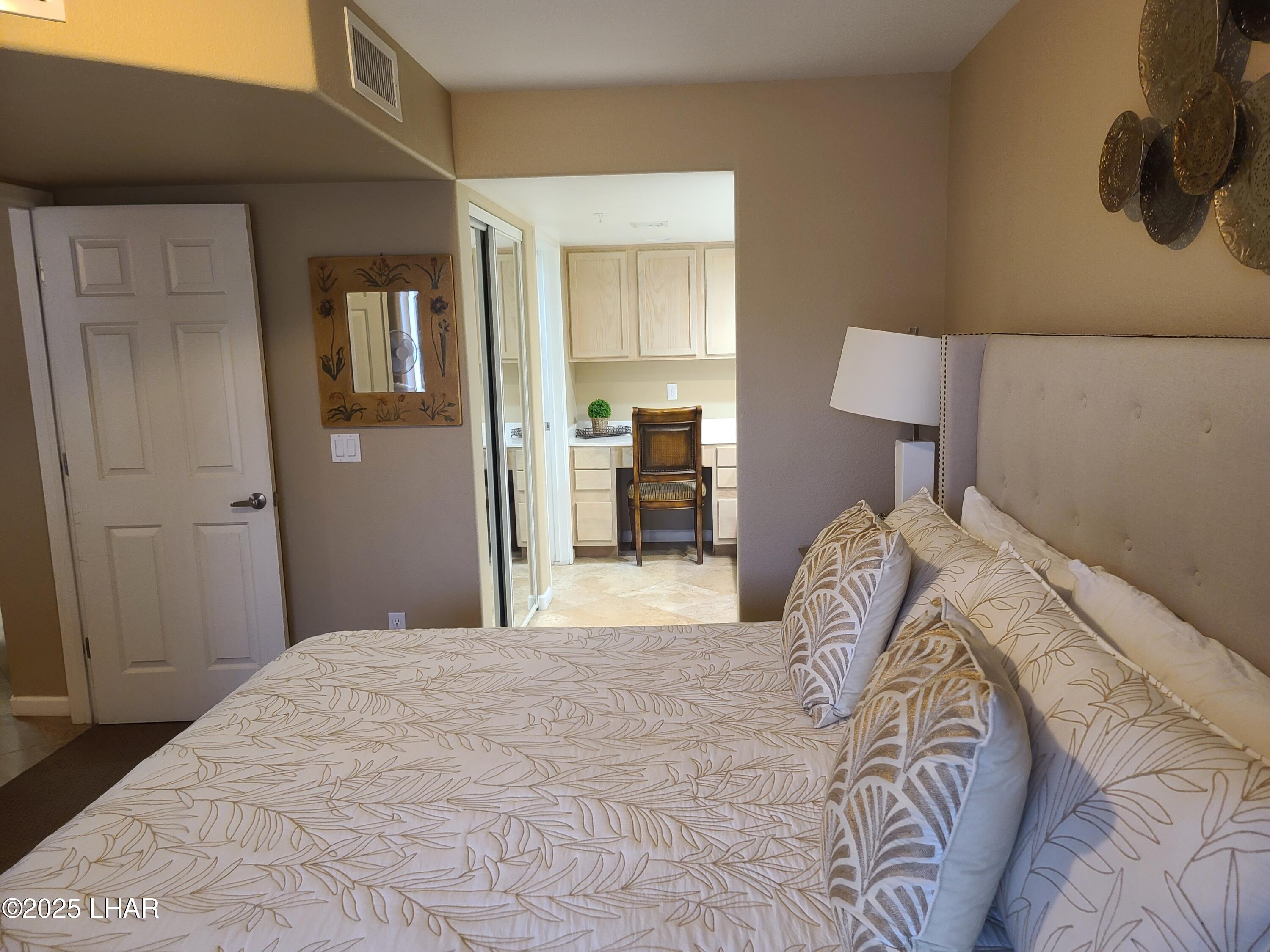 94 London Bridge Road, Unit 108 Lake Havasu City, AZ 86403 - Photo 20 of 38 a bedroom with a bed and a lamp on dresser