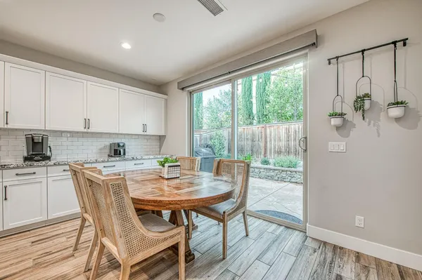 a large kitchen with a table and chairs in it