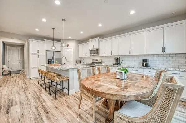 a kitchen with stainless steel appliances granite countertop a stove oven and a refrigerator