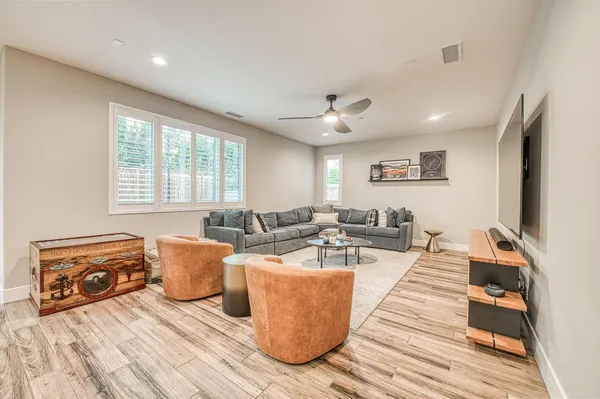 a living room with stainless steel appliances furniture and a kitchen view