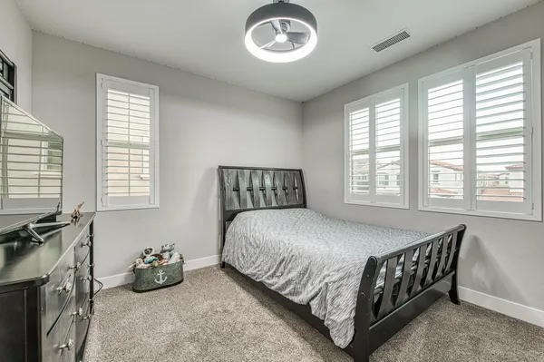 a bedroom with furniture and a window
