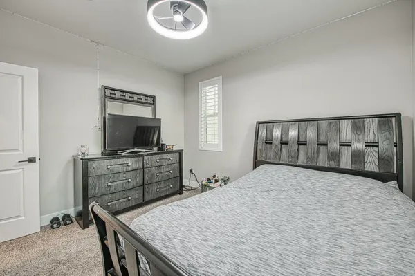 a bedroom with bed and a chandelier