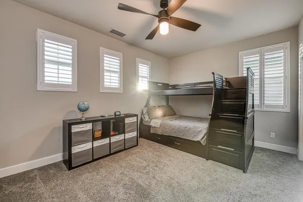 a bedroom with a large bed and a window
