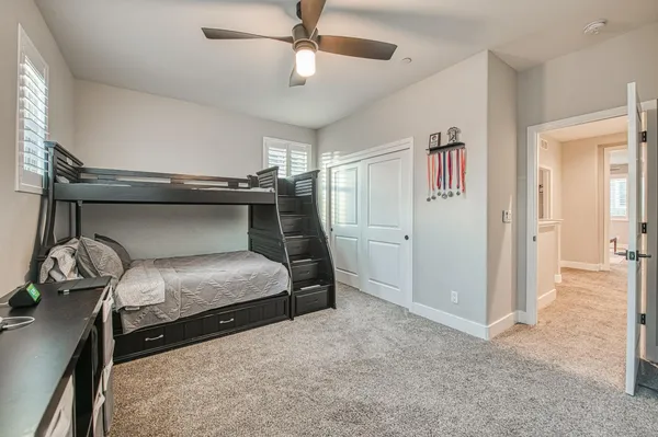 a bedroom with a large bed and a flat screen tv