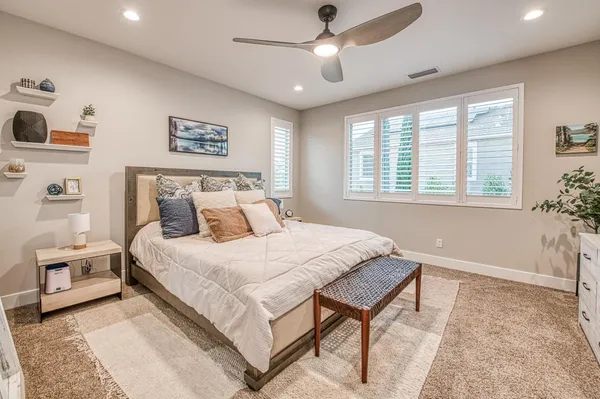 a bathroom with a granite countertop double vanity sink and a mirror