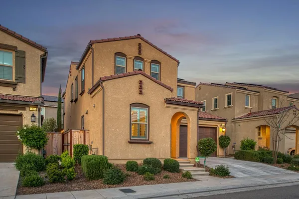 a brick building with a door and a yard
