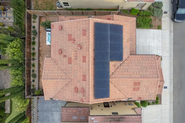 an aerial view of a house with a garden and lake view