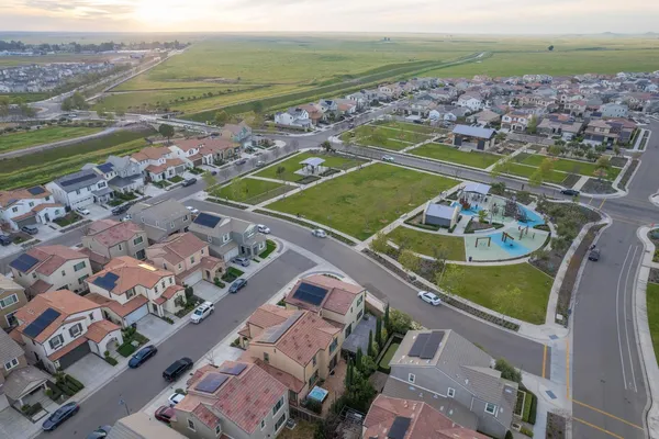 an aerial view of residential houses with outdoor space
