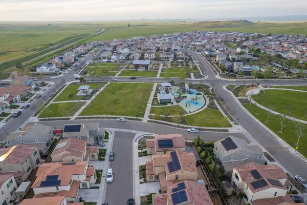 an aerial view of residential houses with outdoor space