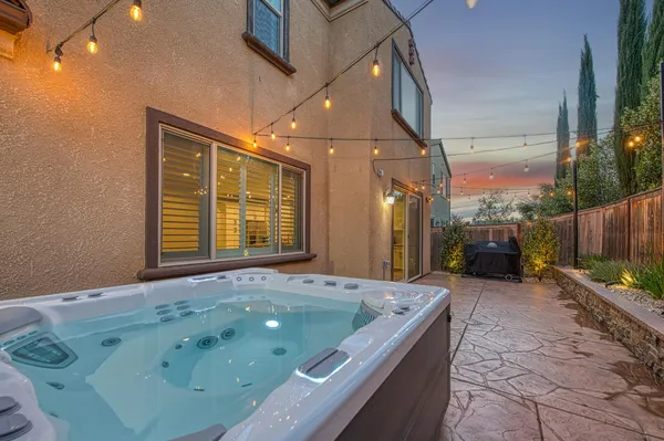 a backyard of a house with table and chairs