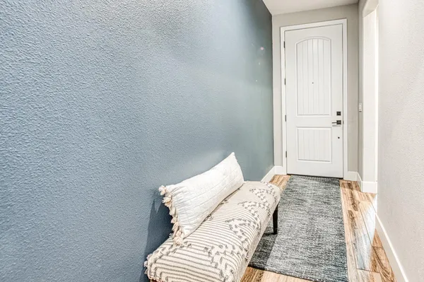 a bathroom with a granite countertop toilet a sink and a mirror