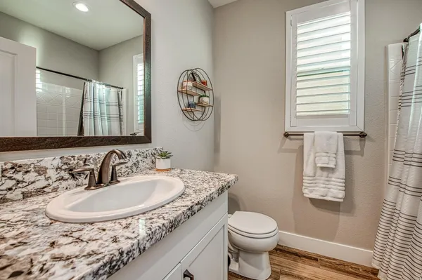 a kitchen with stainless steel appliances granite countertop a stove a refrigerator a oven a sink with a dining table and chairs