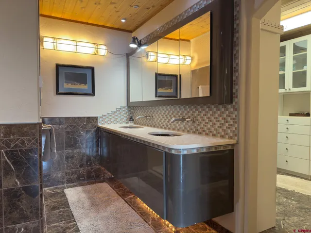 a bedroom with a bed and a lamp