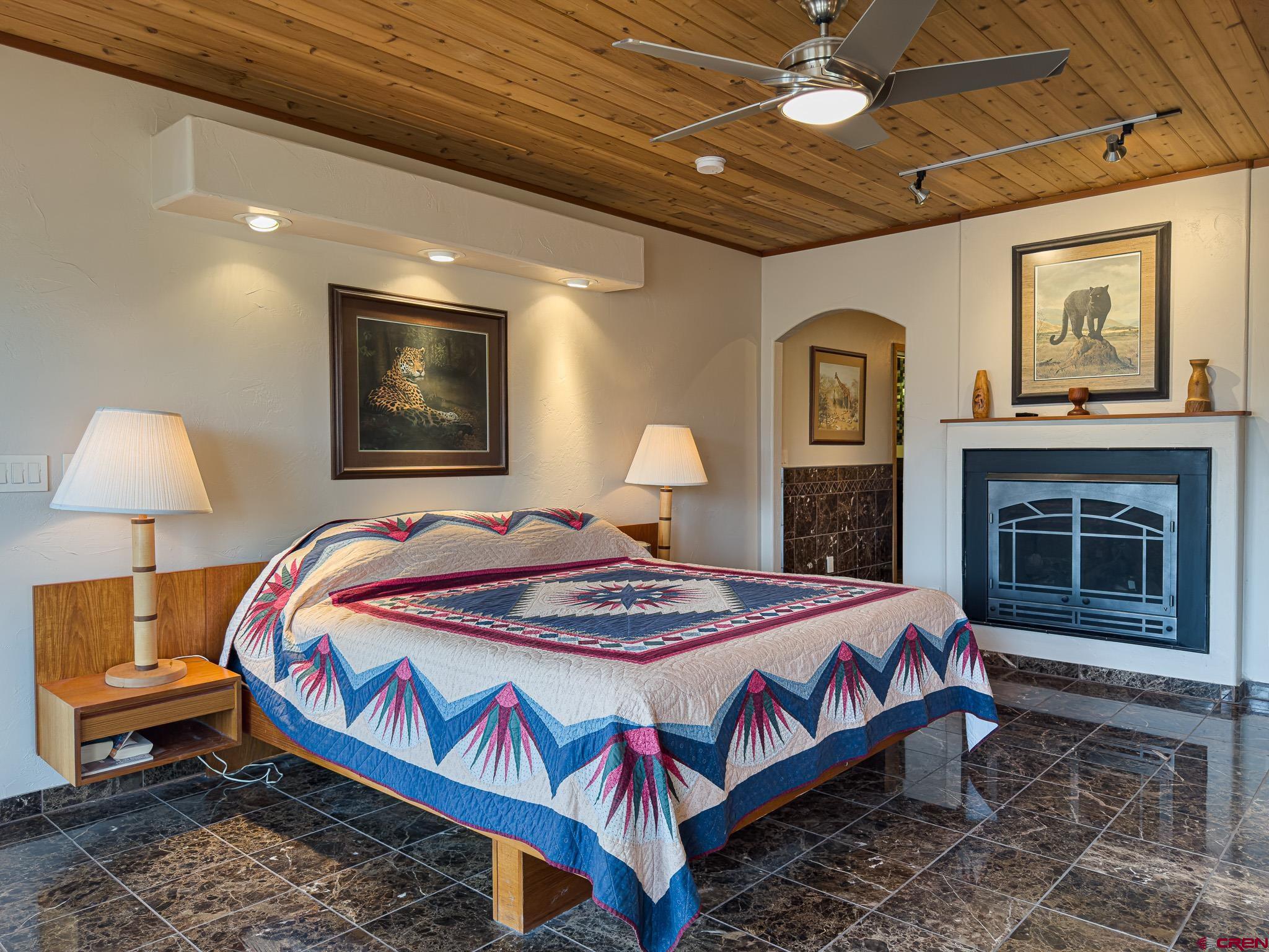 1071 Black Canyon Road Crawford, CO 81415 - Photo 13 of 36 a bedroom with a bed and a lamp