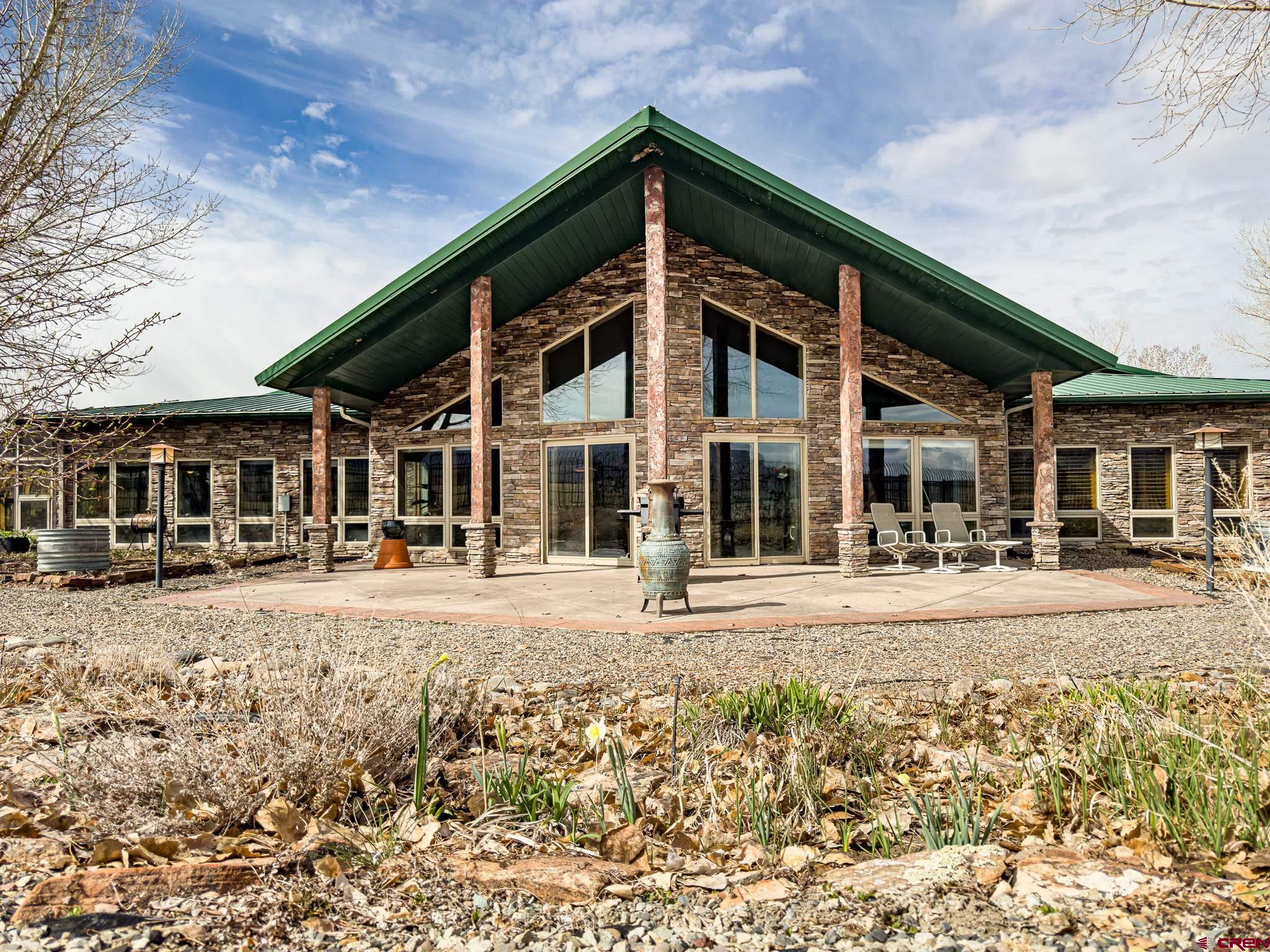 1071 Black Canyon Road Crawford, CO 81415 - Photo 21 of 36 a front view of a house with a yard