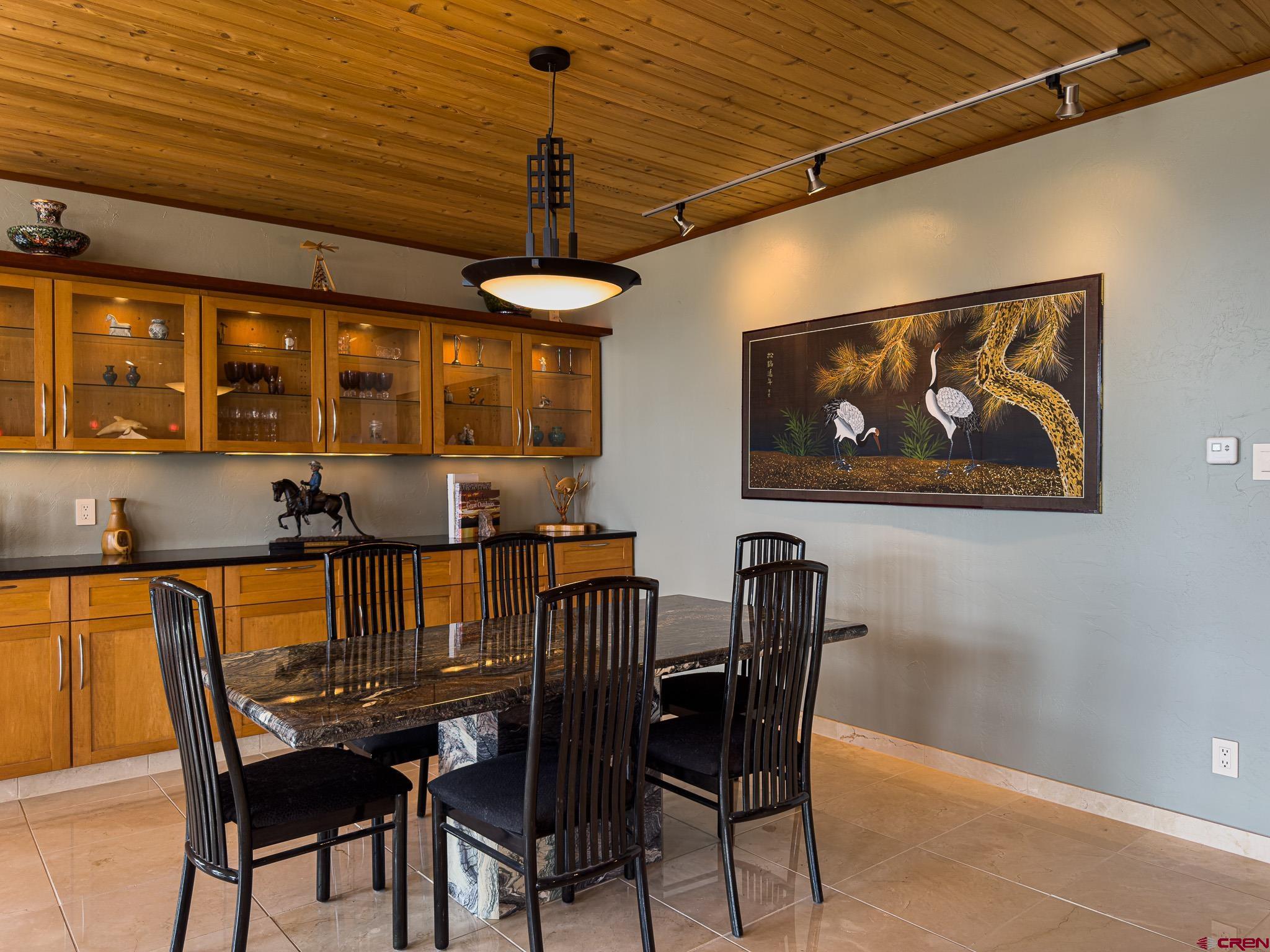 1071 Black Canyon Road Crawford, CO 81415 - Photo 22 of 36 a view of a dining room with furniture and chandelier