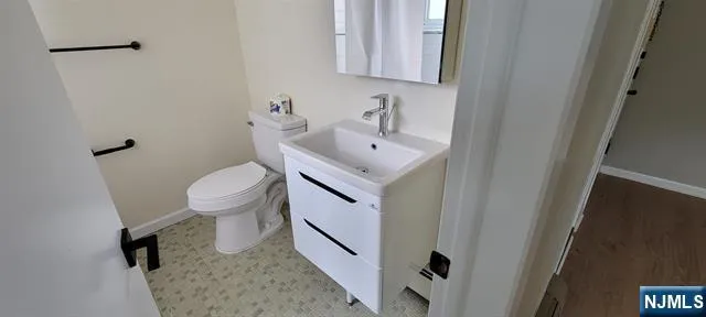 a bathroom with a sink toilet and mirror