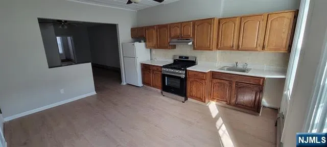 a kitchen with a sink cabinets and stainless steel appliances