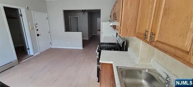 a view of a kitchen from a hallway